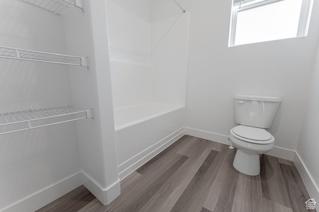 Bathroom with wood-type flooring and toilet