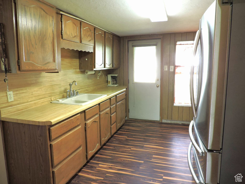 Kitchen with sink, stainless steel fridge, and dark hardwood / wood-style flooring