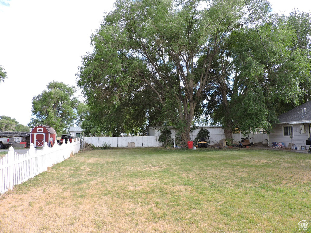 View of yard featuring a storage unit