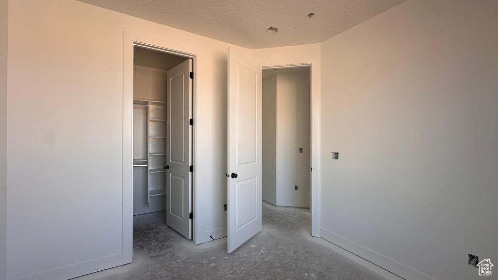 Unfurnished bedroom with a textured ceiling and a closet