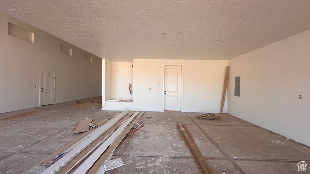 Spare room featuring a textured ceiling and electric panel