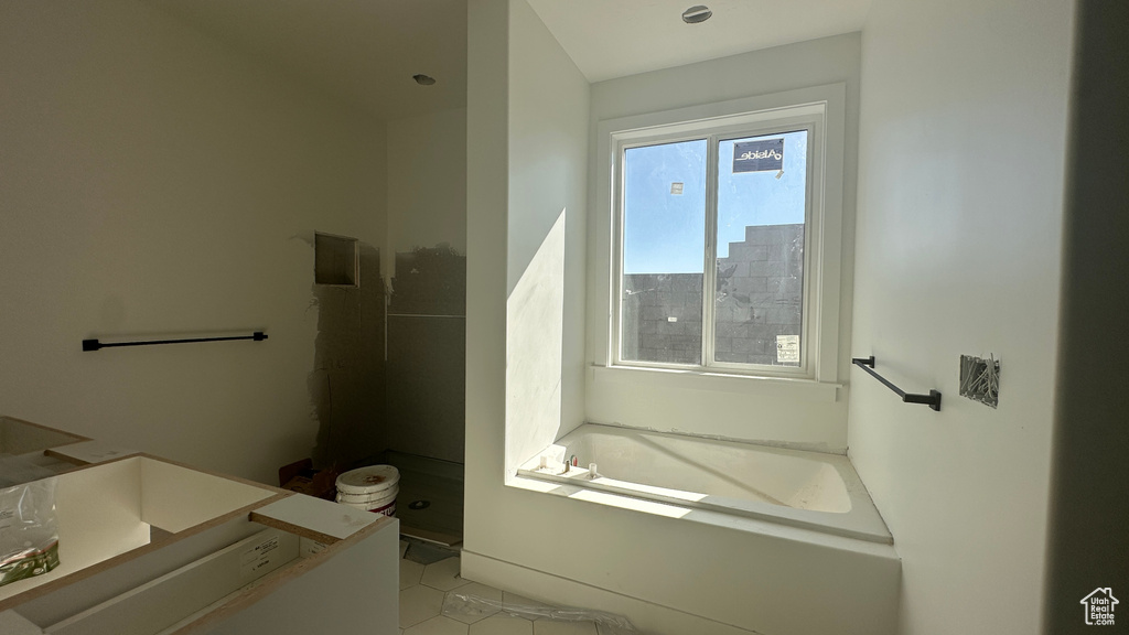 Bathroom featuring vanity, tile patterned floors, and shower with separate bathtub