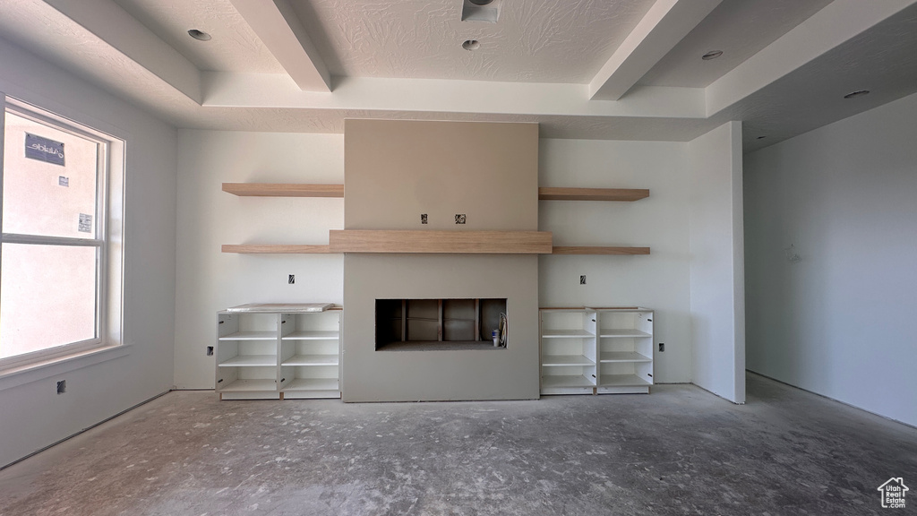 Unfurnished living room featuring a textured ceiling and a fireplace