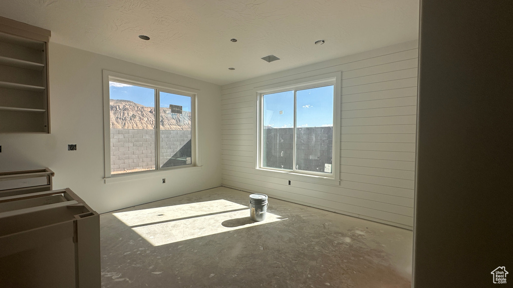 Interior space with a mountain view, a healthy amount of sunlight, and a textured ceiling