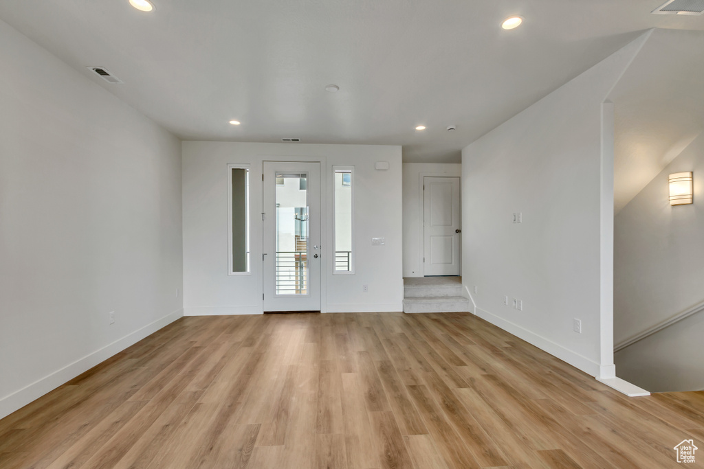 Entrance foyer with light hardwood / wood-style floors