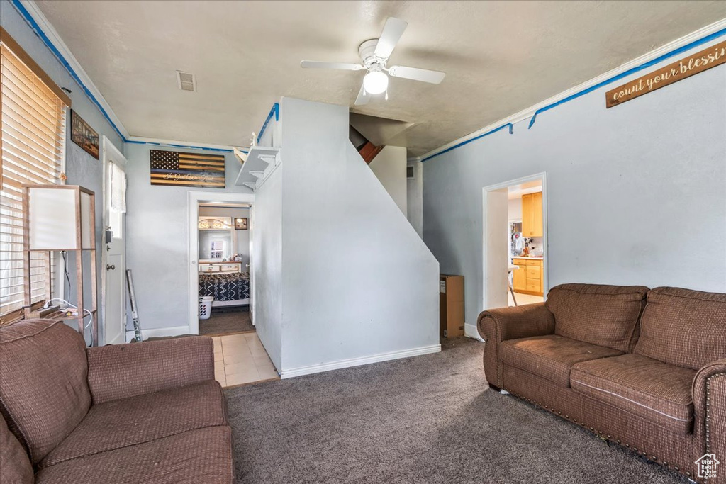 Carpeted living room with ceiling fan