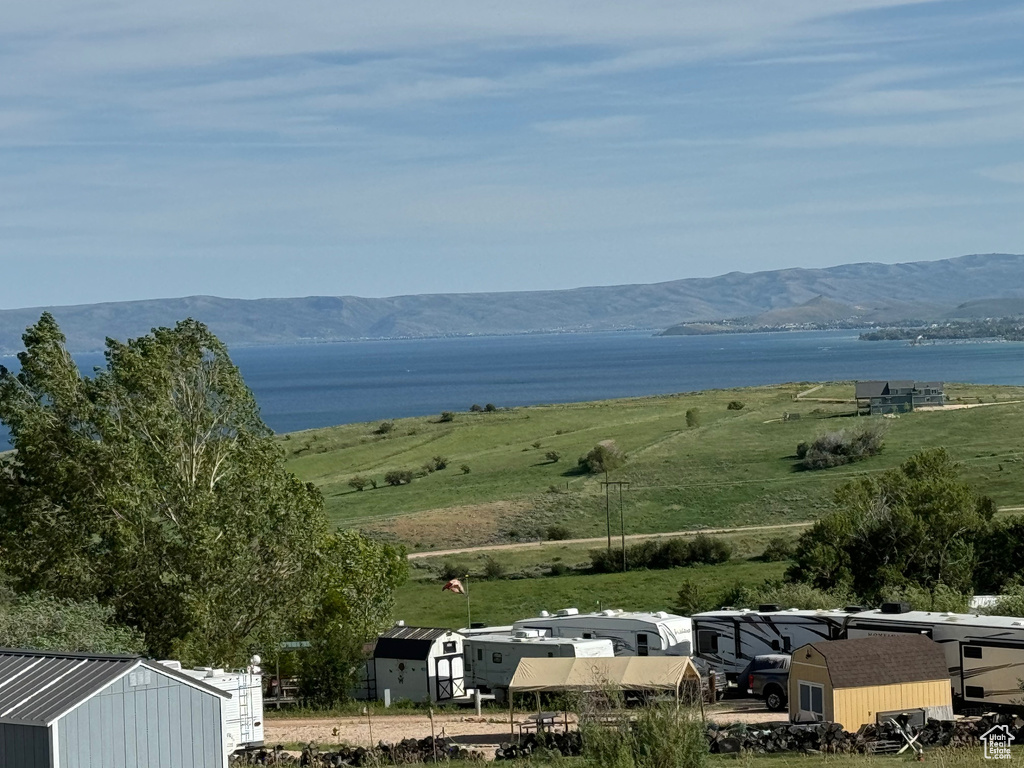 Property view of mountains featuring a rural view and a water view