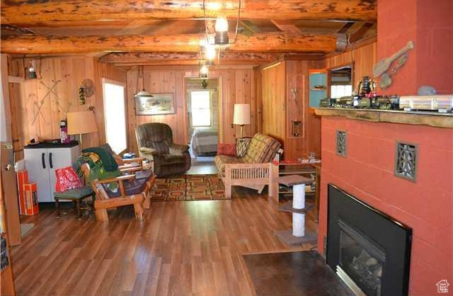 Living room with beam ceiling and hardwood / wood-style floors