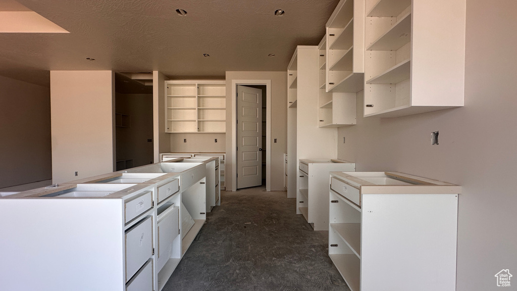 Kitchen featuring white cabinets and a textured ceiling