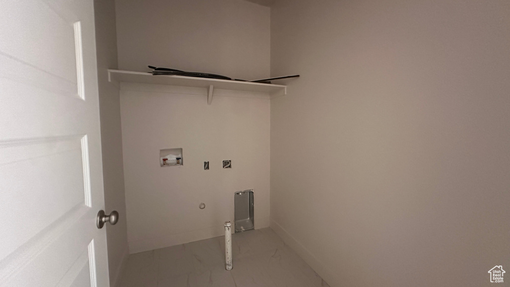 Washroom with hookup for a gas dryer and hookup for a washing machine