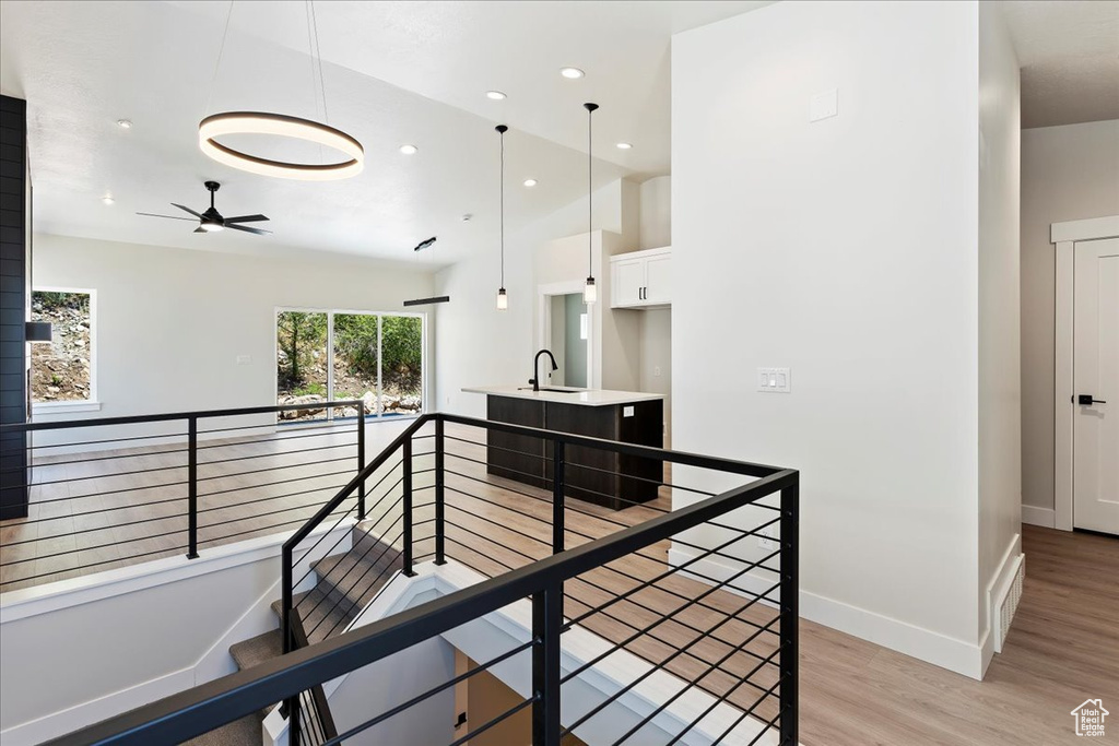 Corridor featuring light hardwood / wood-style floors and sink