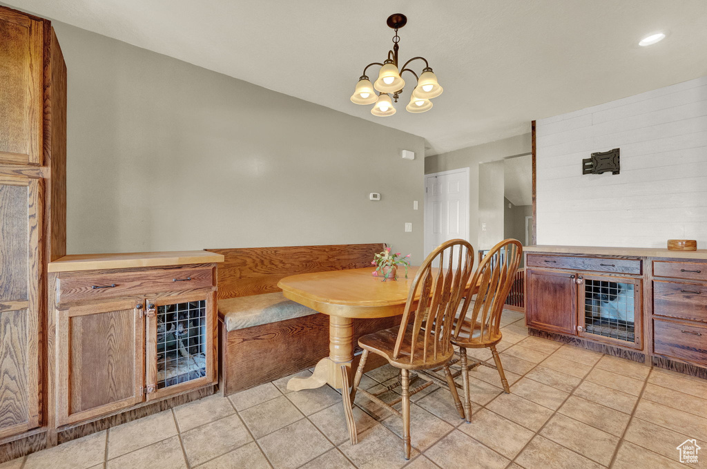 Dining space featuring an inviting chandelier and light tile floors