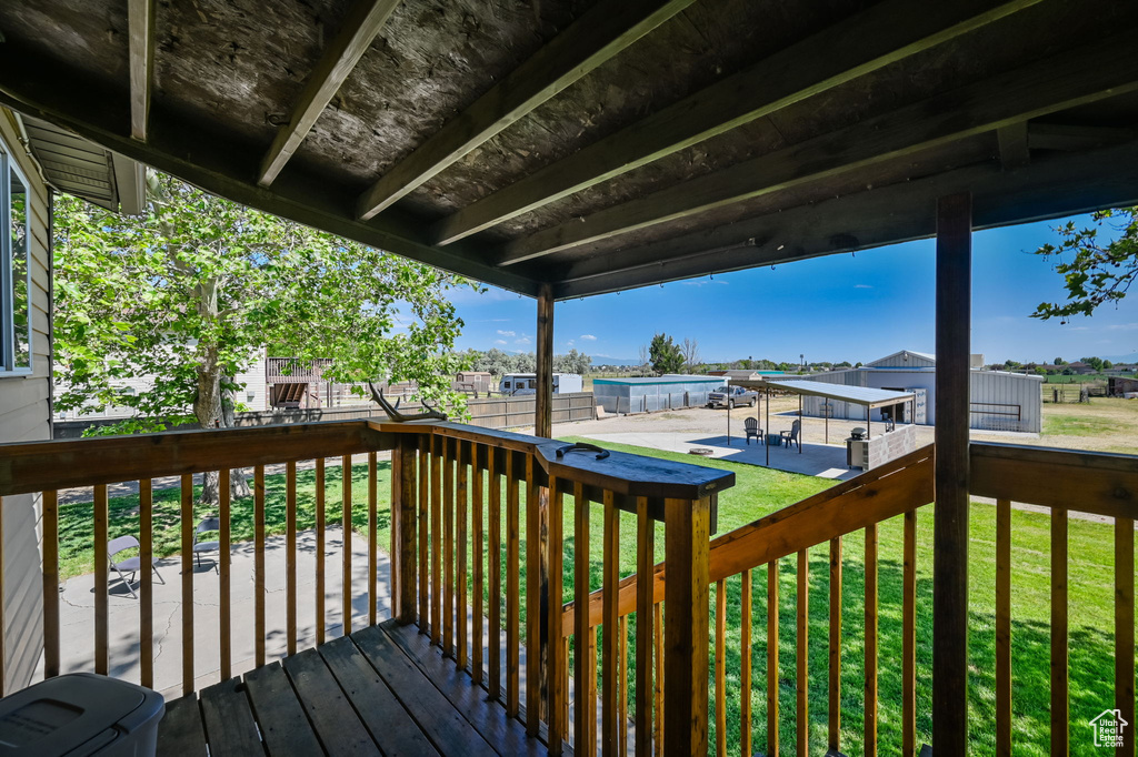 Wooden deck with a swimming pool and a lawn