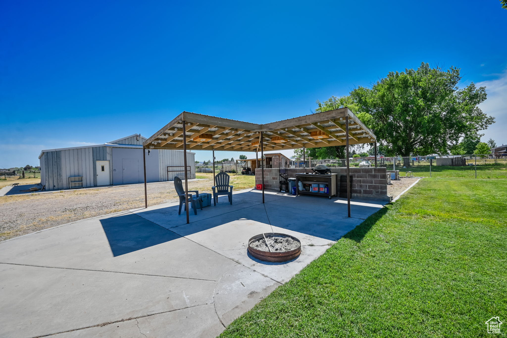 Exterior space featuring a pergola and a fire pit