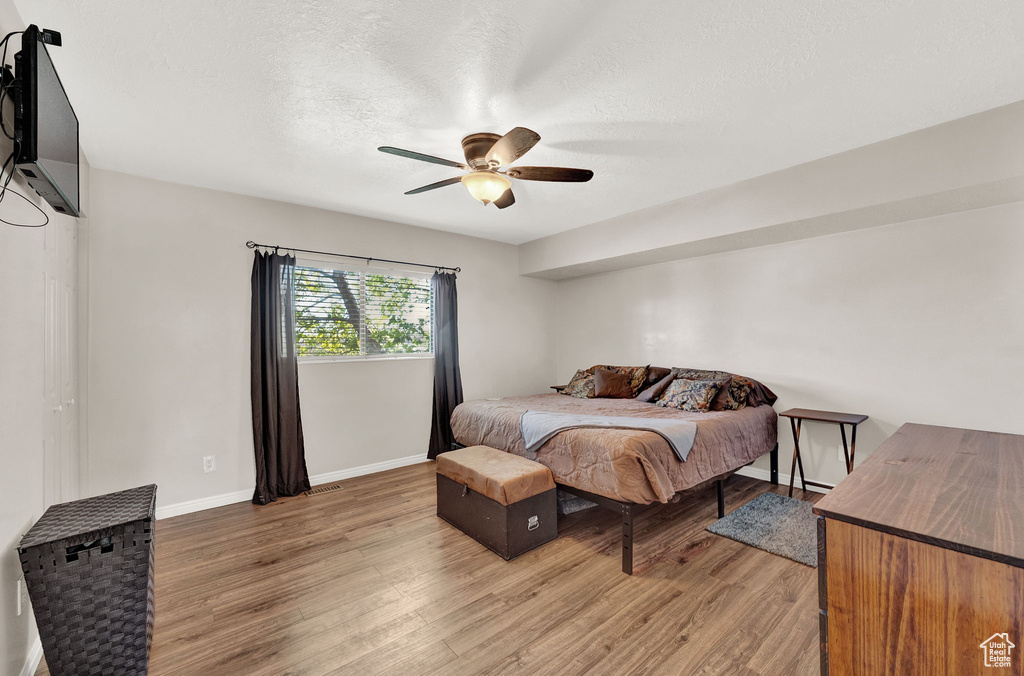 Bedroom with wood-type flooring and ceiling fan