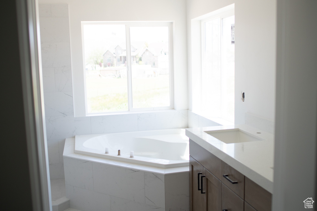 Bathroom featuring vanity and a bath