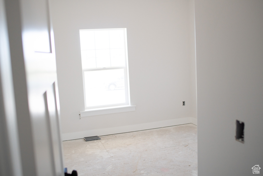 Spare room featuring baseboards