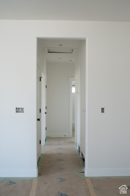 Corridor featuring baseboards