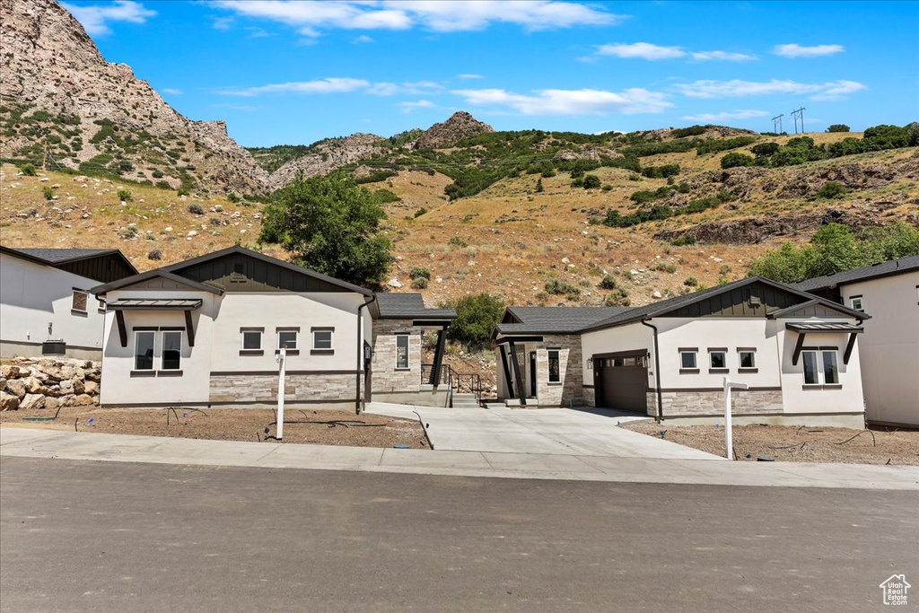 View of front of home featuring a garage and a mountain view