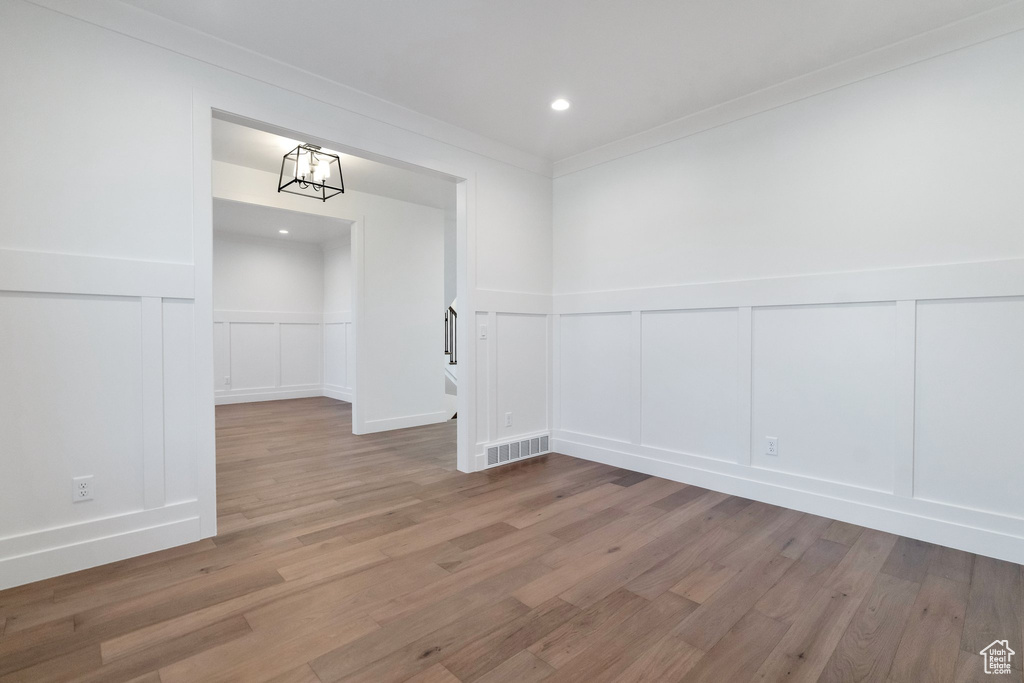 Interior space featuring hardwood / wood-style floors and crown molding