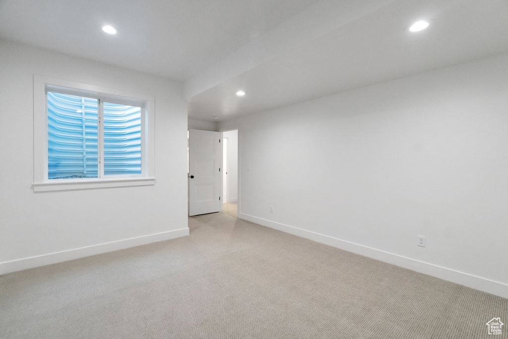 Unfurnished room featuring light carpet