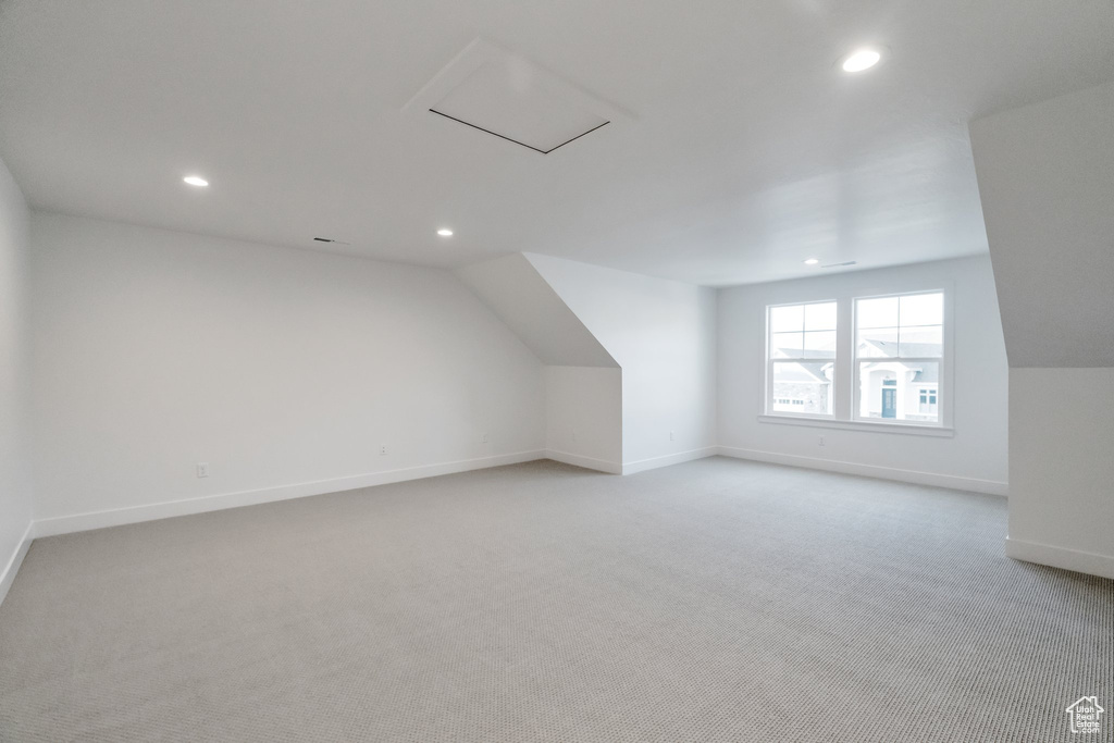 Bonus room featuring carpet flooring and lofted ceiling