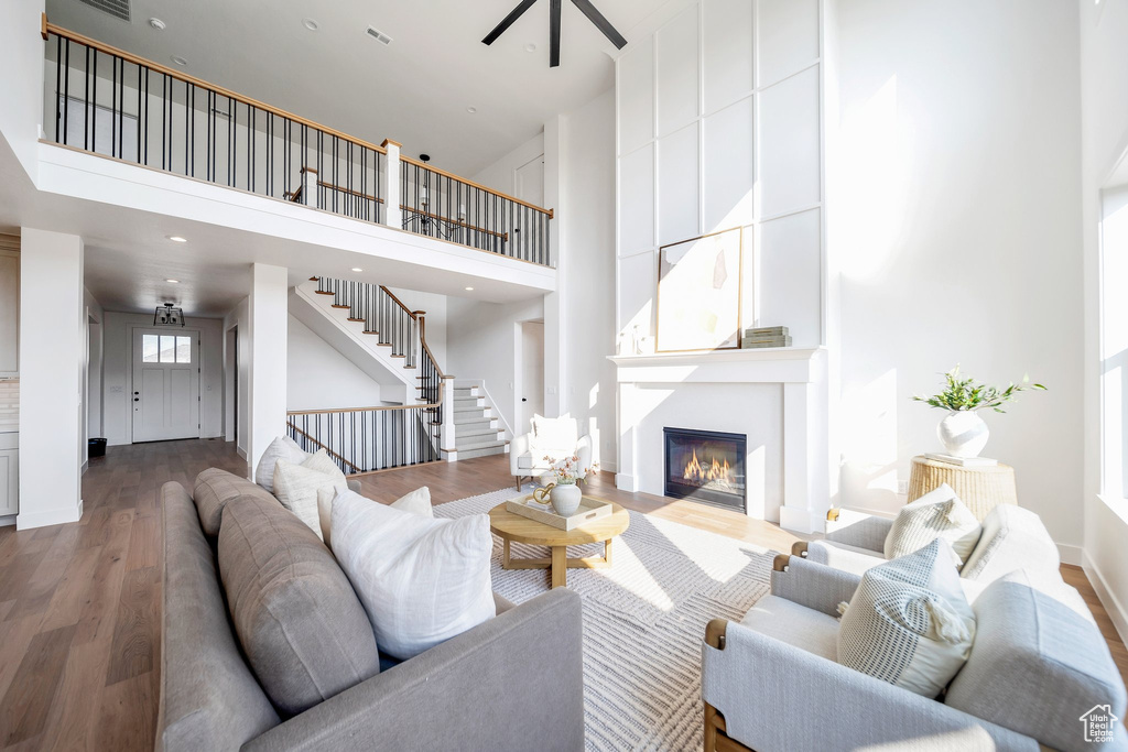 Living room with a high ceiling and hardwood / wood-style flooring