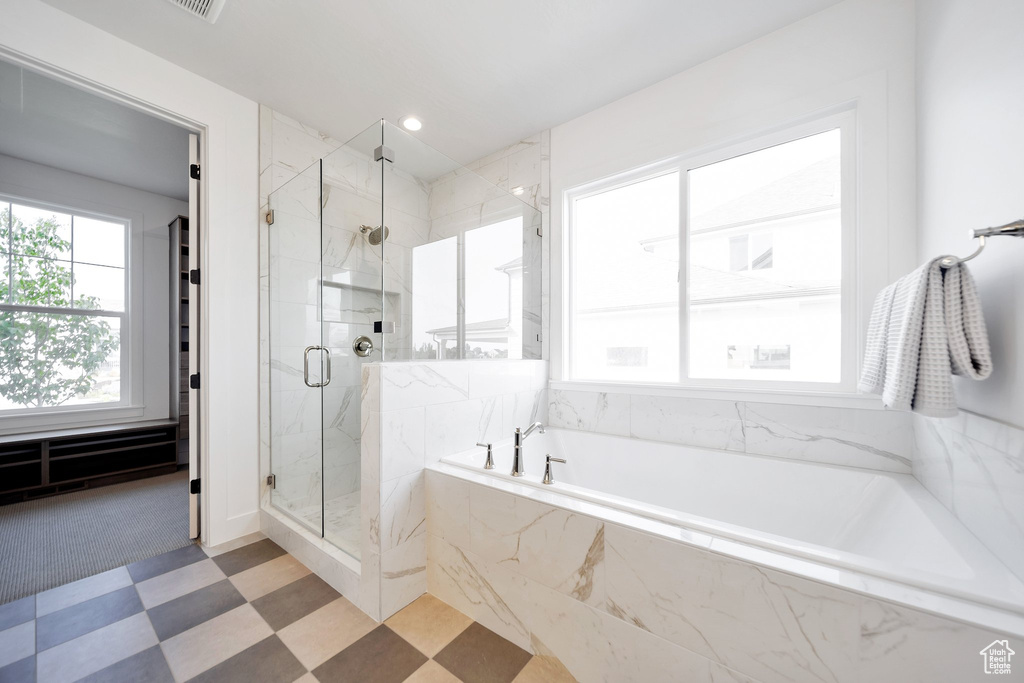 Bathroom with plus walk in shower and tile patterned floors