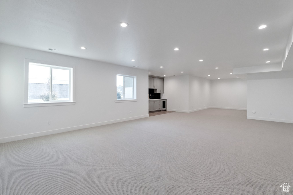 Basement with light colored carpet