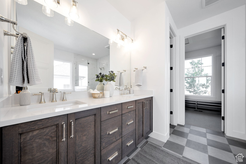 Bathroom with tile patterned flooring and double sink vanity