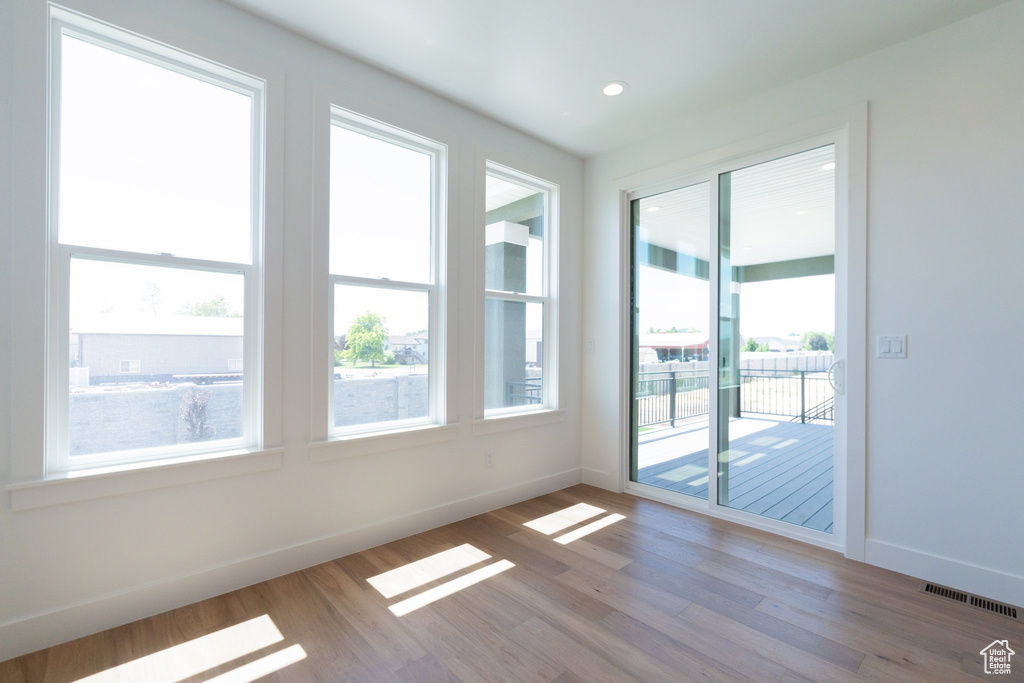 Spare room featuring hardwood / wood-style flooring and a wealth of natural light