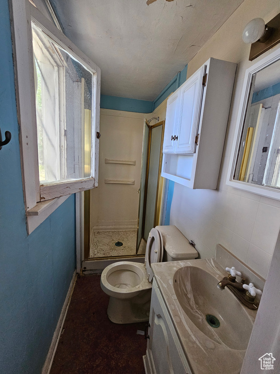 Bathroom with oversized vanity, toilet, and a shower