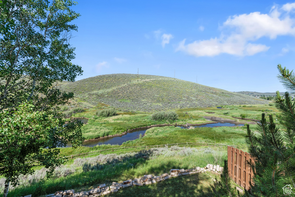 Property view of mountains with a water view