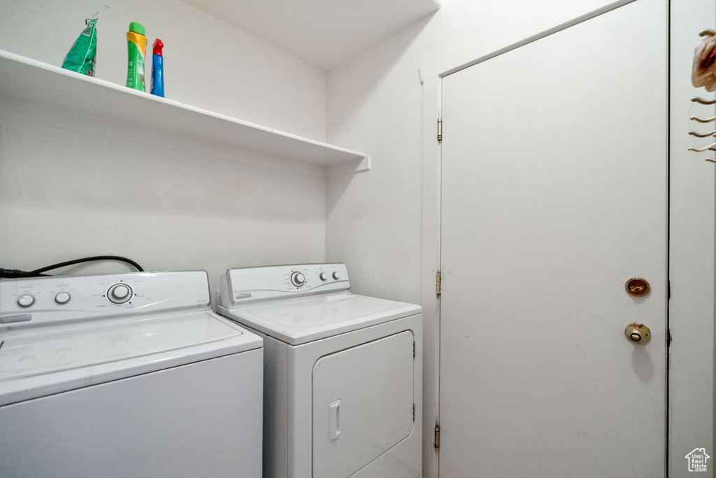 Clothes washing area featuring washer and dryer