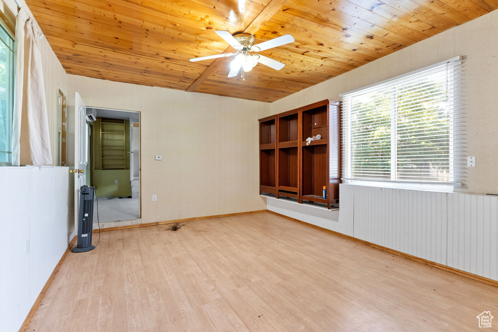 Spare room with wooden ceiling, ceiling fan, light hardwood / wood-style floors, and radiator heating unit