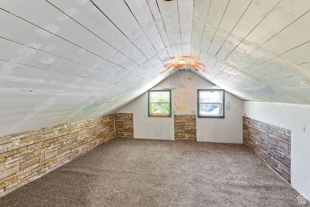 Bonus room with carpet and vaulted ceiling