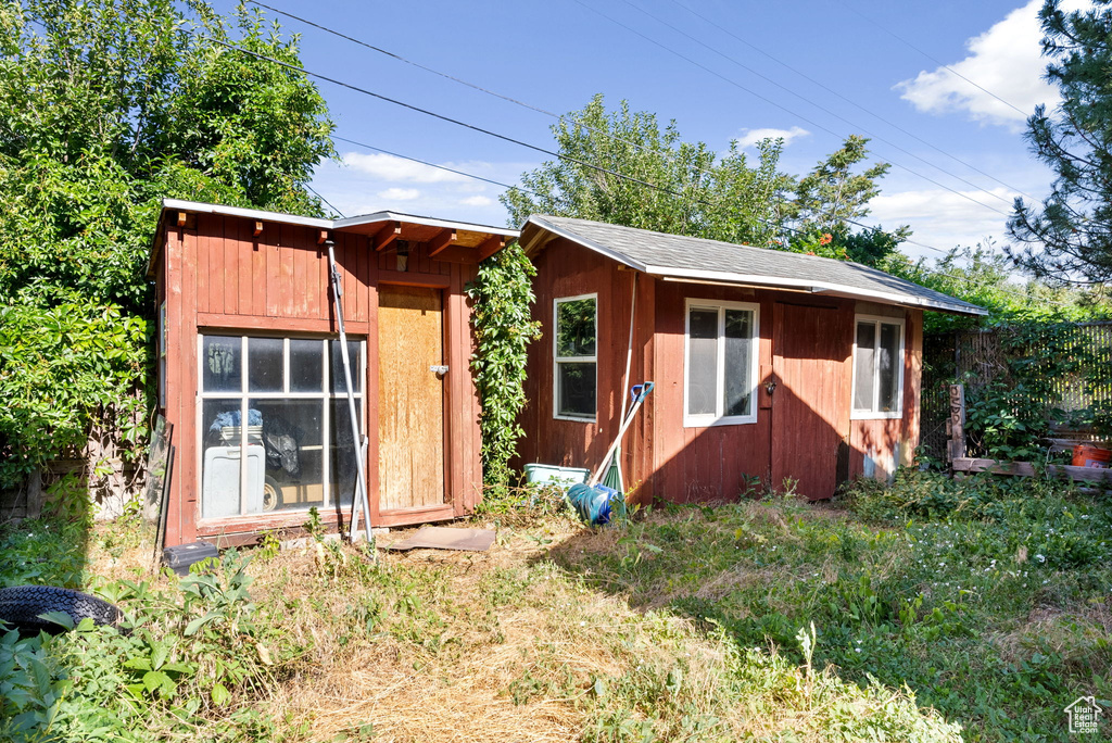 Back of property featuring an outdoor structure