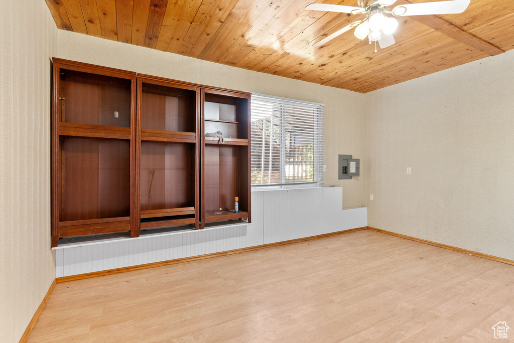 Unfurnished room with ceiling fan, light wood-type flooring, and wooden ceiling