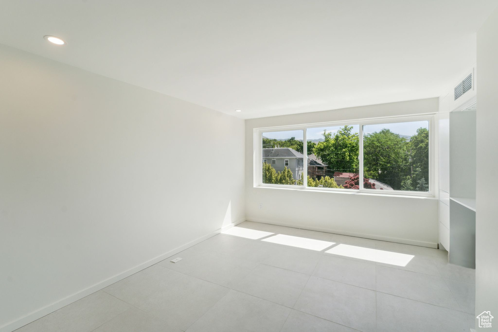 Spare room featuring light tile flooring