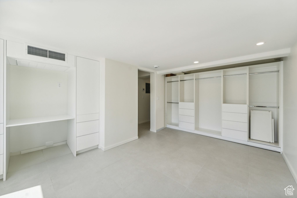 Unfurnished bedroom featuring a closet and light tile floors