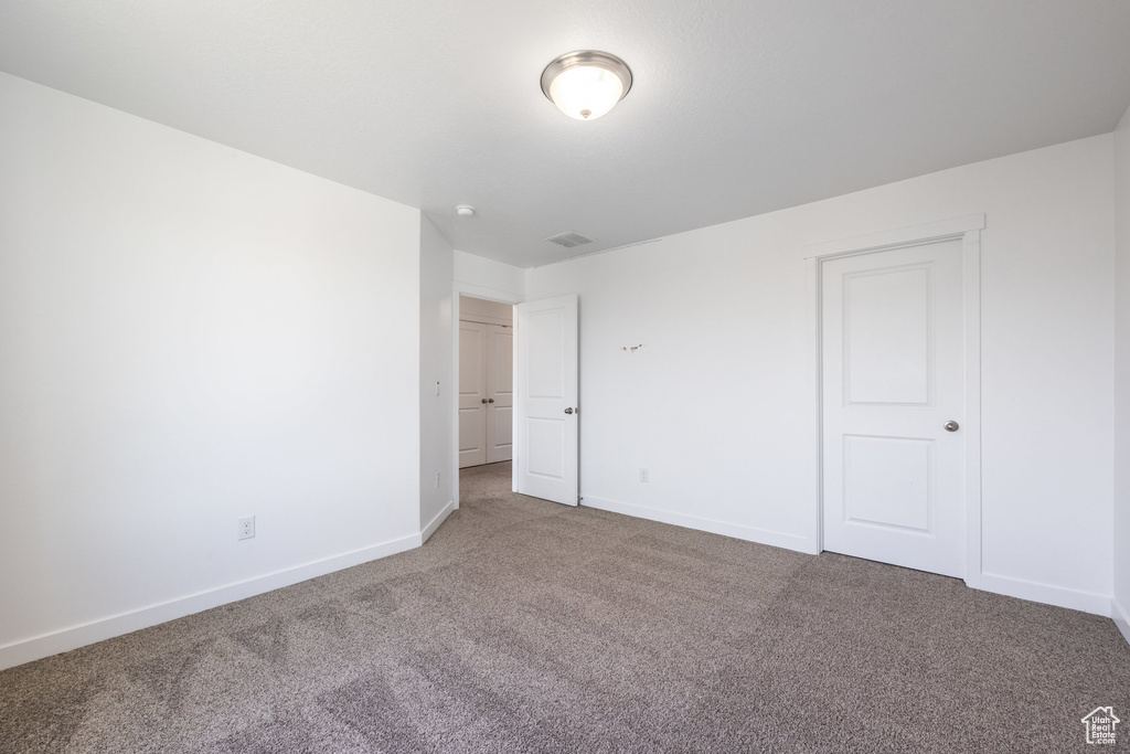 Unfurnished bedroom featuring carpet flooring