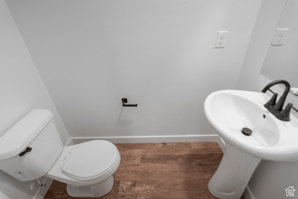 Bathroom featuring hardwood / wood-style flooring and toilet