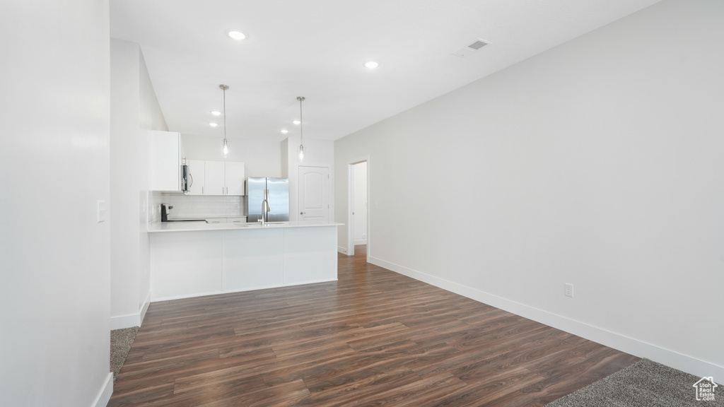 Unfurnished living room with dark wood-type flooring