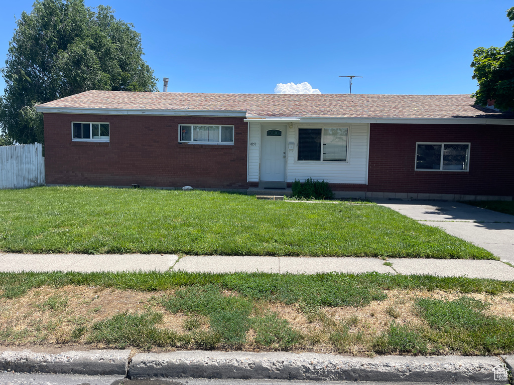 Single story home with a front lawn