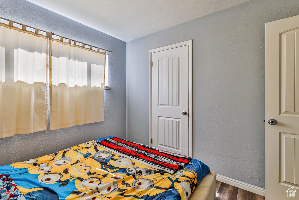 Bedroom with hardwood / wood-style flooring