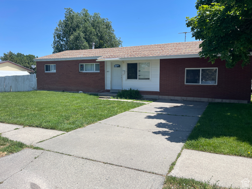 Single story home featuring a front yard