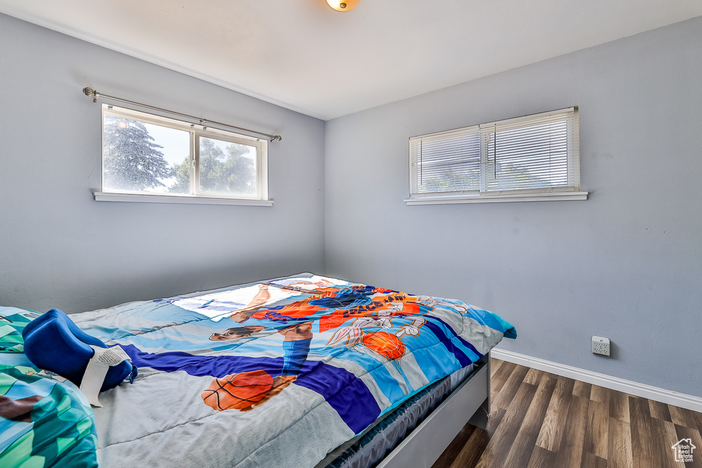 Bedroom with dark hardwood / wood-style floors