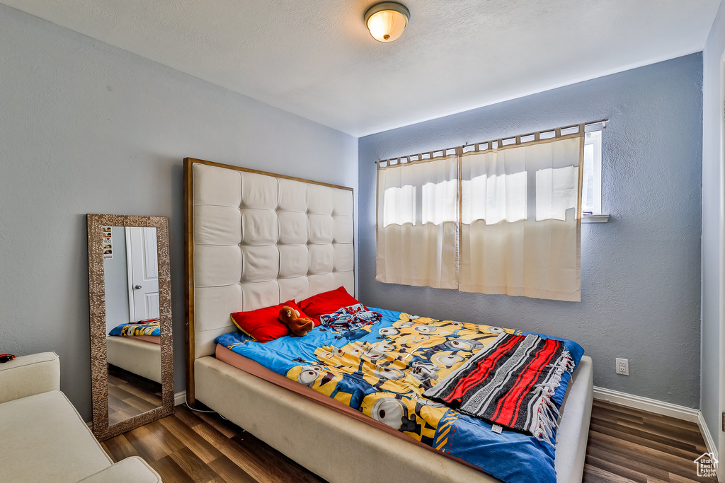 Bedroom with dark wood-type flooring