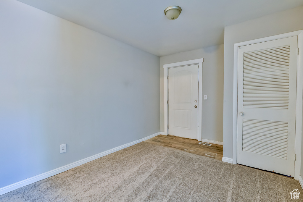 Unfurnished bedroom featuring light colored carpet