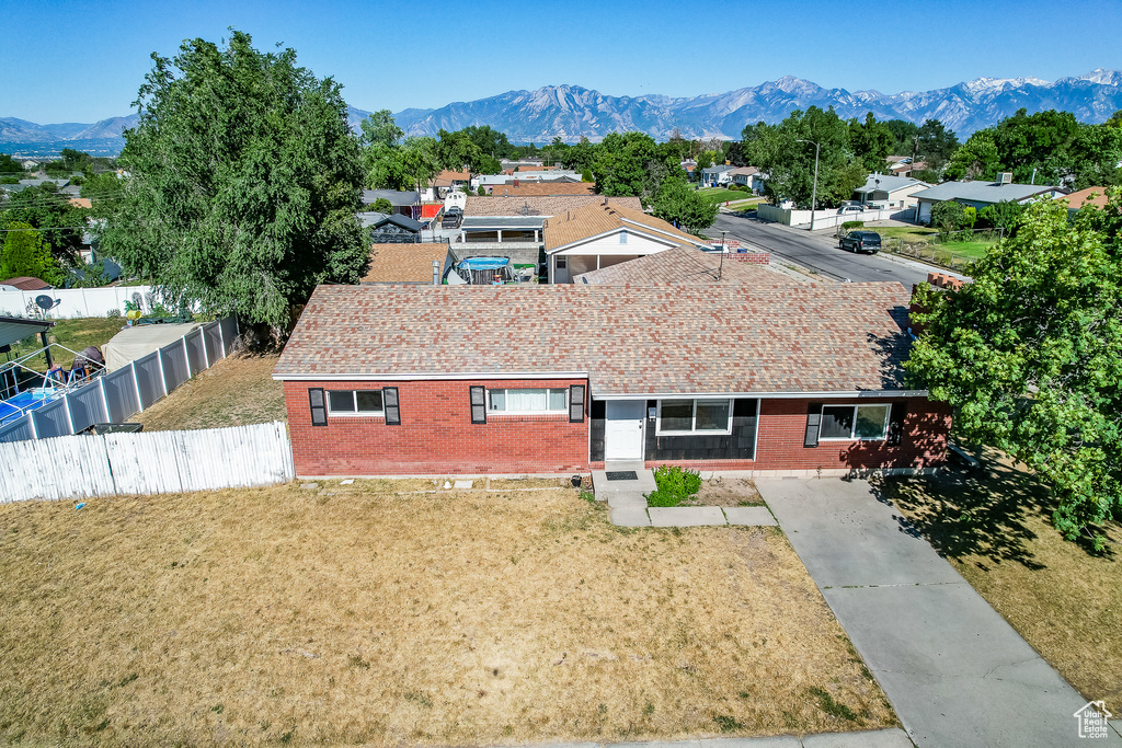 Ranch-style home featuring a mountain view and a front yard